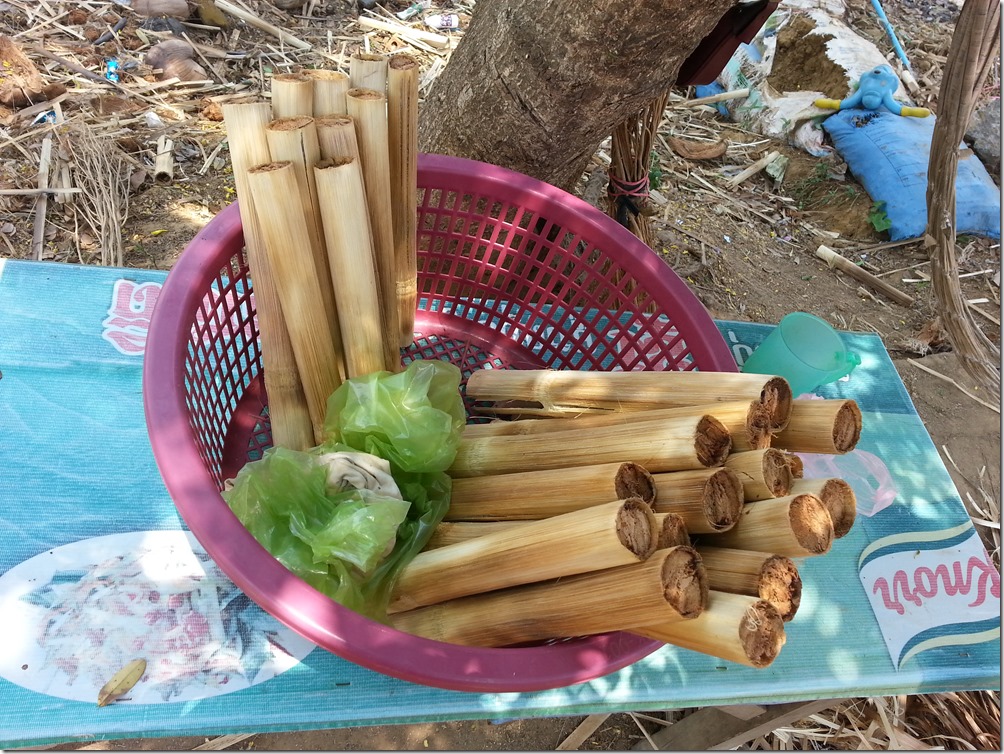 Bamboo sticky rice for sale at a roadside stand.